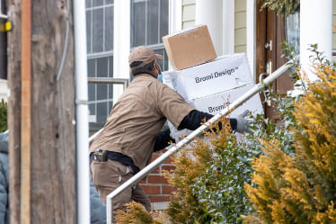 A man delivering packages to a home.