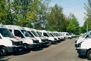 White trucks parking side by side in a lot.