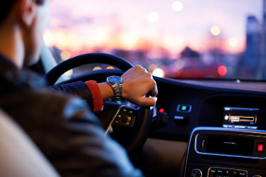 A person driving their car inside of the vehicle.